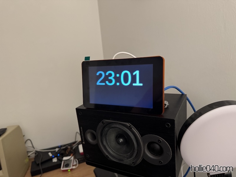 A white text clock on a black background displayed on a 7" display
